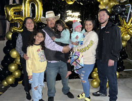 Ramiro Brito Sanchez celebrates his 50th birthday surrounded by loved ones, including his wife, children, and grandchildren.