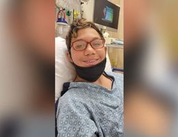 Teen boy smiling for photo after surgery