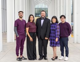 infectious disease team of three men and two women standing outside