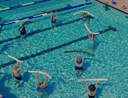 overhead shot of people doing water aerobics in a large pool