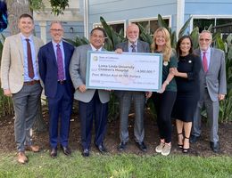 Hospital and government officials with large check