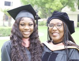 two Black women in graduation regalia