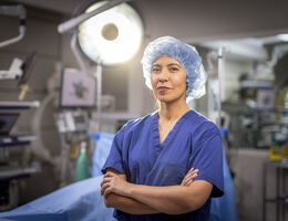 Dr. Andrea Salcedo stands facing camera in operation room