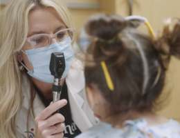 female doctor examines pediatric female patient