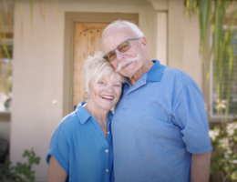 a woman and man smile together while holding each other