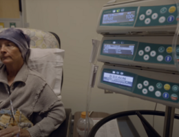 a woman sits in a chair while receiving a medical treatment 