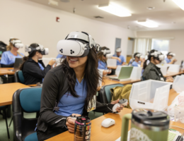 Nursing student wearing VR goggles in a classroom setting