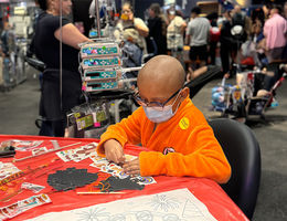 LLUCH pediatric male patient in Aang costume from avatar, sits at table and colors