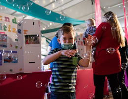 Young boy playing with bubbles