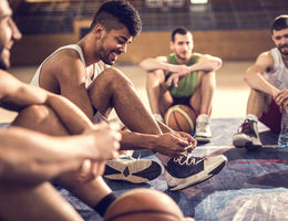 5 common sport injuries: what you need to know Young men taking a break from basketball