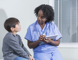 Doctor talking to child patient
