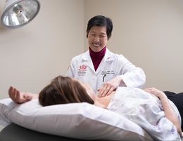 Dr. Lum performs a breast exam on a patient