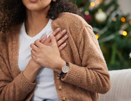 a woman uses both hands to hold her chest