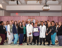Two Loma Linda University Health facilities receive American Heart Association awards Group of doctors and staff stand in a large group holding an award