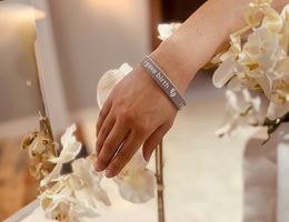 close up of a woman wearing an "I gave birth bracelet" arounod her wrist