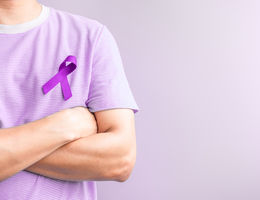 Man wearing purple ribbon for testicular cancer awareness