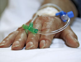 Close up shot of IV in older person's hand