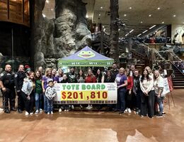 Staff and volunteers hold final total check