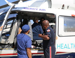 transport team member looks into helicopter during training