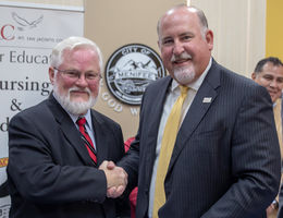 Dr. Carter and Dr. Schultz Dr. Carter and Dr. Schultz shake hands after signing the agreement