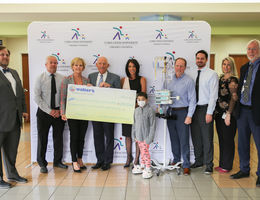 Walter’s Children’s Charity Classic raises more than $257,000 for Children’s Hospital group of administration stand with female patient