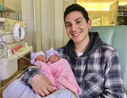 Twin girls born minutes after start of 2020 young father holds twin girls