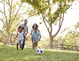Top five things parents can do to help their type 2 diabetic child Family Playing Soccer In Park Together