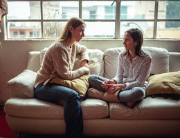 Educating your children on STIs — expert says it doesn’t have to be awkward mother and daughter sitting on couch having a talk
