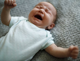 Little baby boy crying with opened mouth 