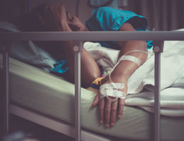 sick woman lying in hospital bed 
