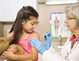 Doctors encourage annual vaccinations as flu season approaches Young Hispanic girl gets a flu shot