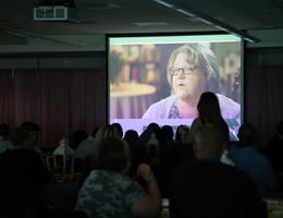 VIDEO: Woman survives Stage 4 colon cancer, returns to her calling video playing for audience