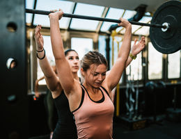 A guide to resuming strenuous physical activity following a COVID-19 infection woman lifting weights