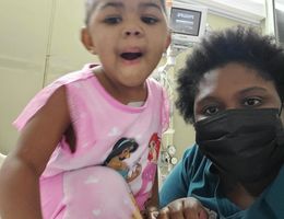Young Black girl in hospital room