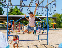 Kids playing on a playground during summer