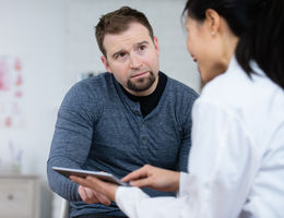 How some urology issues in men may signal greater health concerns man sitting with a doctor