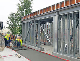 Concrete finishing work around the base of the future valet parking building nears completion. Valet parking building nears completion
