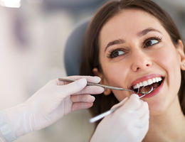 Dentists checks patients teeth
