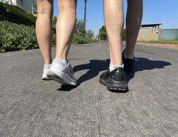 two people walking on concrete 