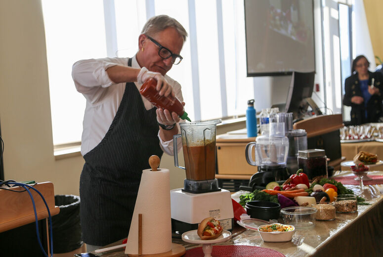Bill Schuler, MD, lead the cooking demonstration during the community event. 