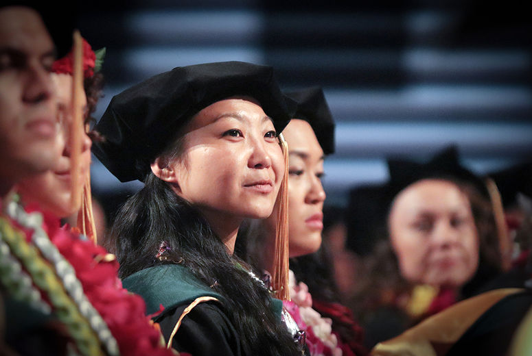 Joyful expectation illumines the face of a graduate.