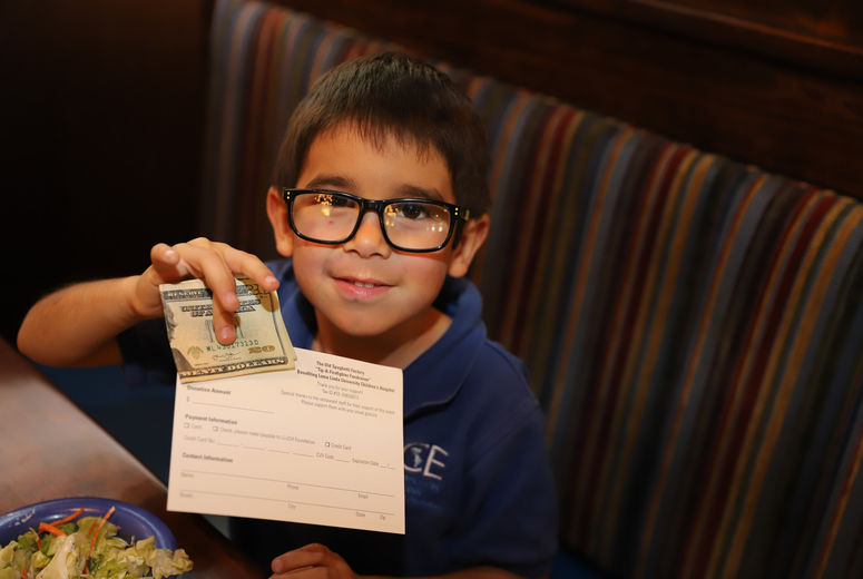 boy holding money in his hand The Old Spaghetti Factory restaurant 
