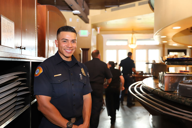 firefighter standing for a photo at the Old Spaghetti Factory restaurant 