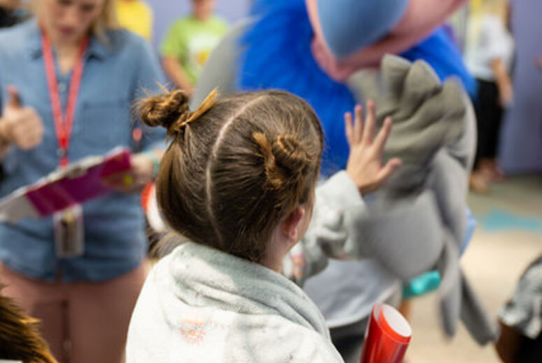 Patient high-fives mascot
