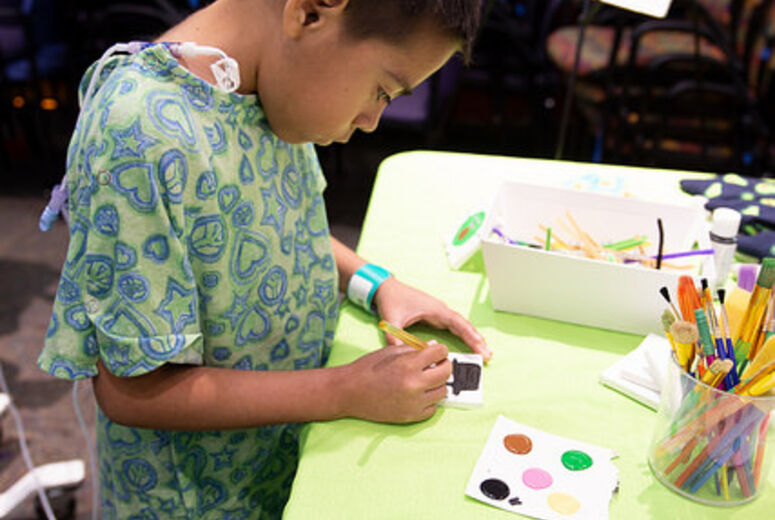Patient painting at a booth