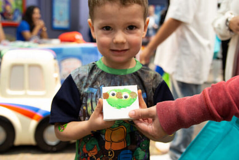  Boy smiling and showing off his painting