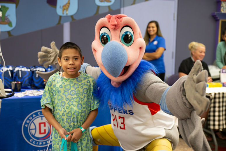 Patient and mascot stand together