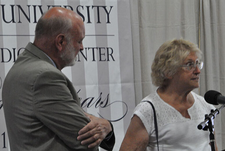 Dr. Hart invites Lyn Behrens up to the stage