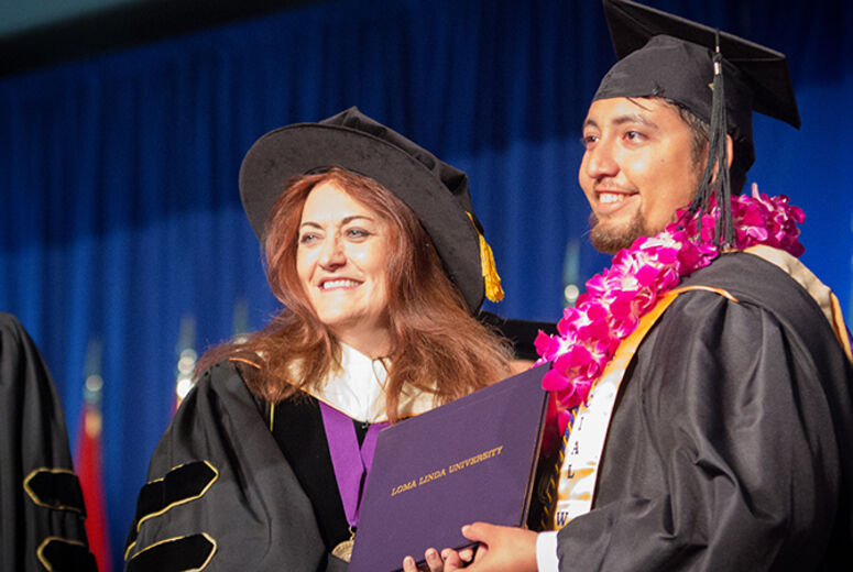 Dean Beverly Buckles, DSW, and one of her graduates of the School of Behavioral Health share matching grins. 