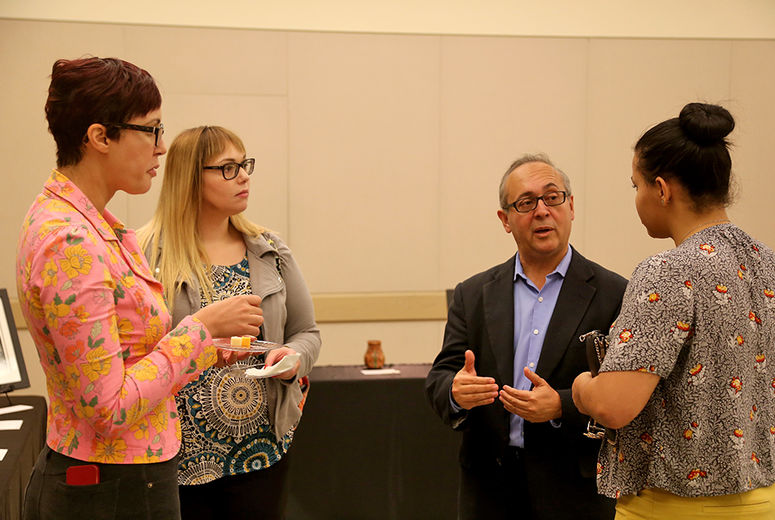 Carlos Casiano, PhD, with Leanne Burnham (left), Christina Du Ross (center), and Alfida Fernandez.